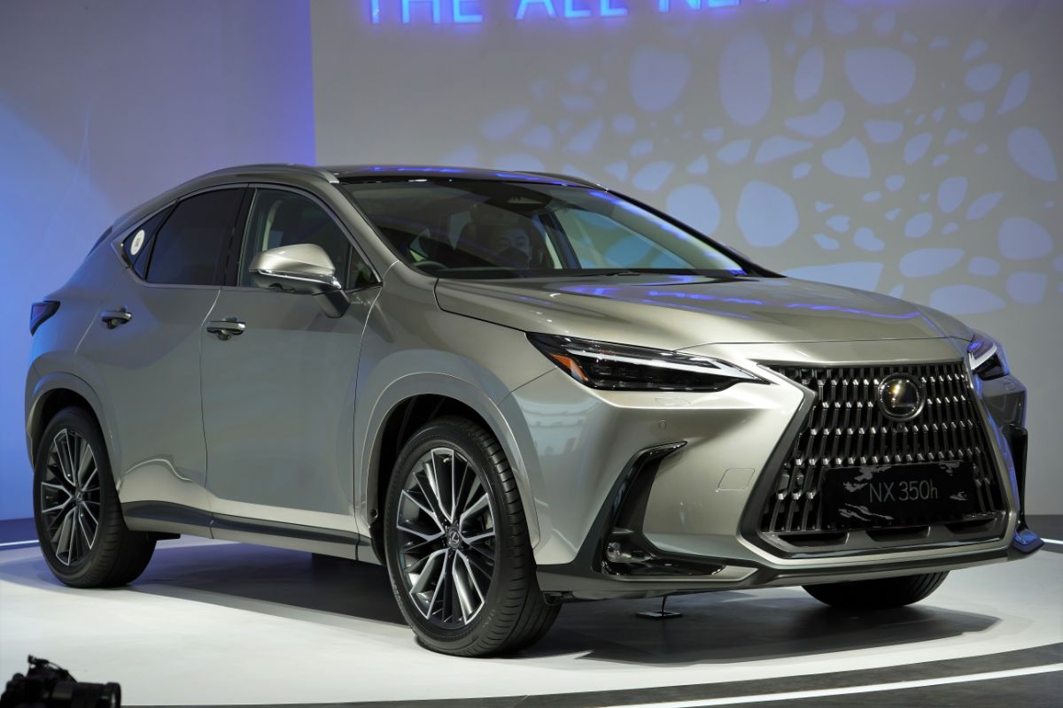 A display of a shiny Lexus IS on a white floor.