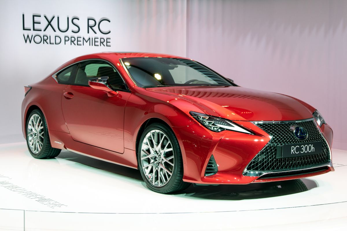 World premiere of gleamy red Lexus RC presented on a white floor.