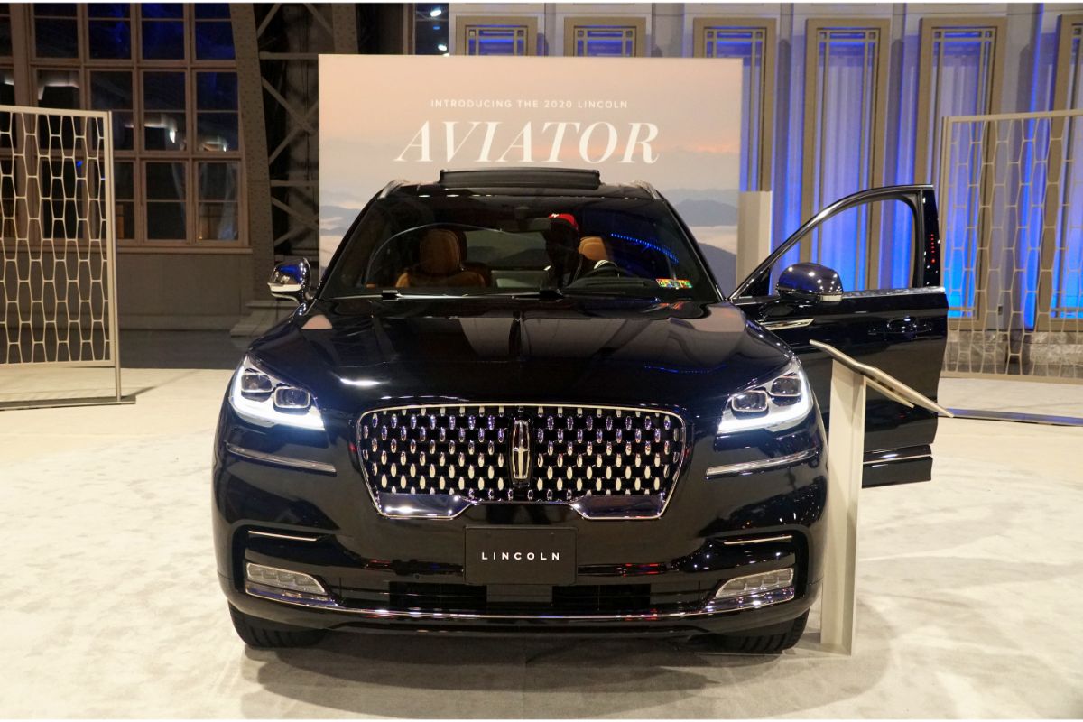 Front view of a black Lincoln Aviator car with the left door open.