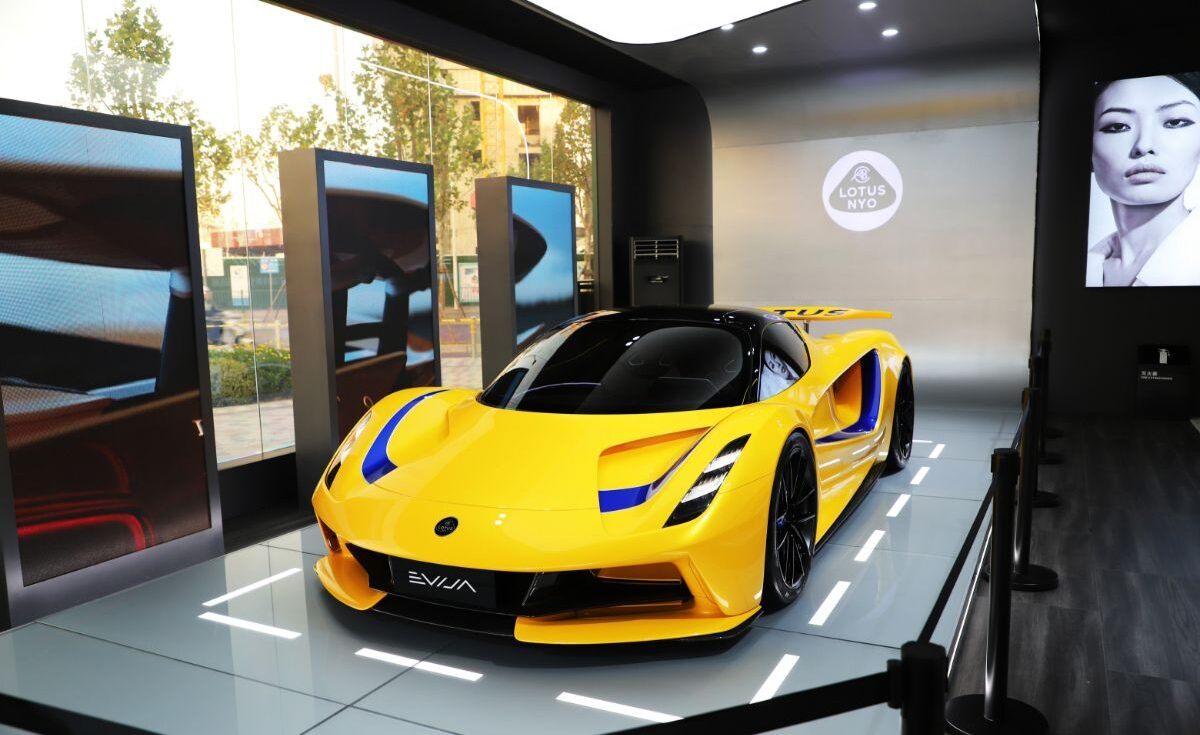 A dazzling look of yellow Lotus Evija car at the modern room for car.