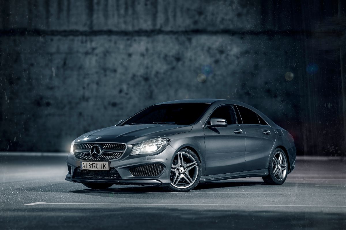 Closeup of grey car Mercedes Benz CLA 200 AMG on a blacl background.