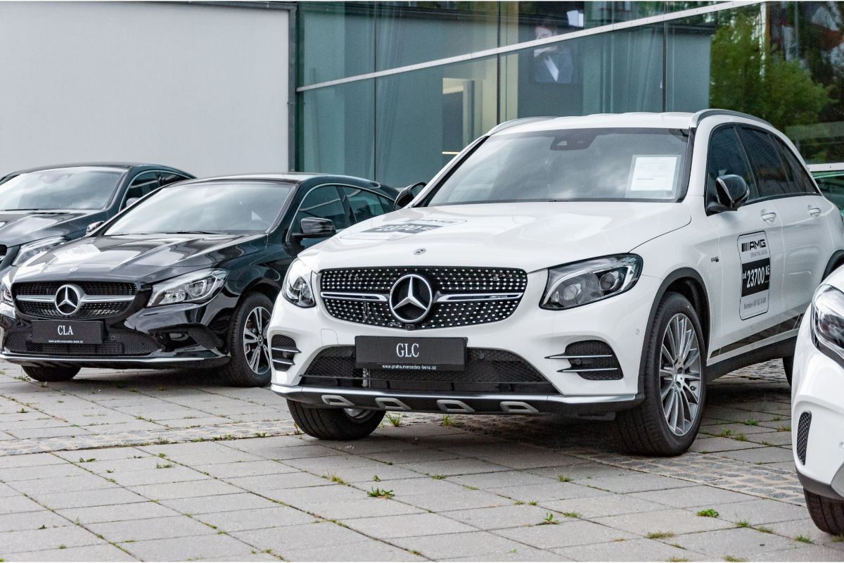 A photo of Mercedes-Benz GLC cars in different color parked at a dealership.