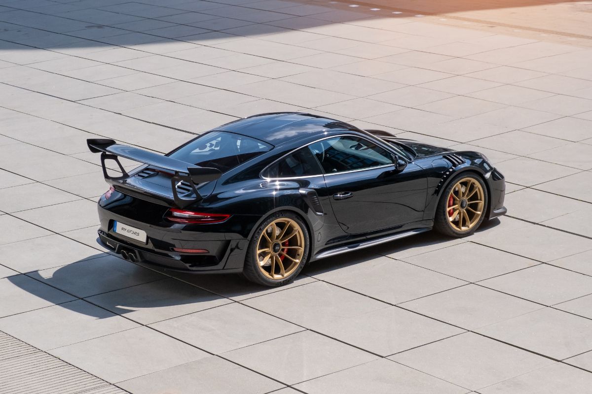 Back view of a contemporary Porsche 911 GT3 taken in a staged street scene.