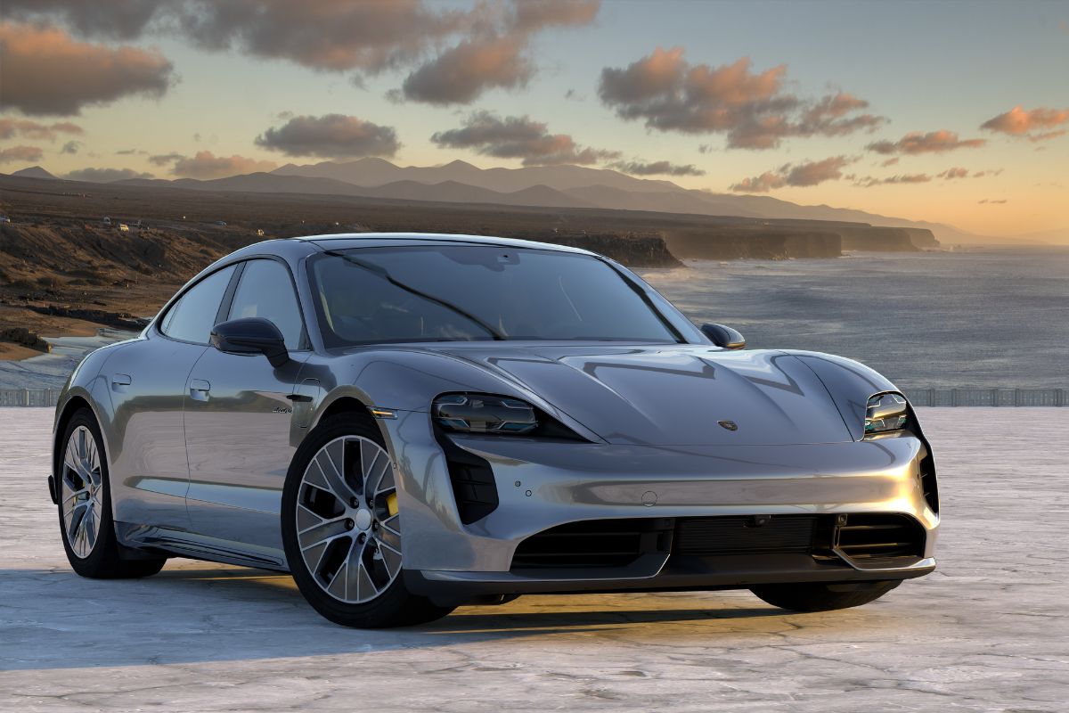 Grey Porsche Taycan parked in a prominent location with a panoramic view was photographed.