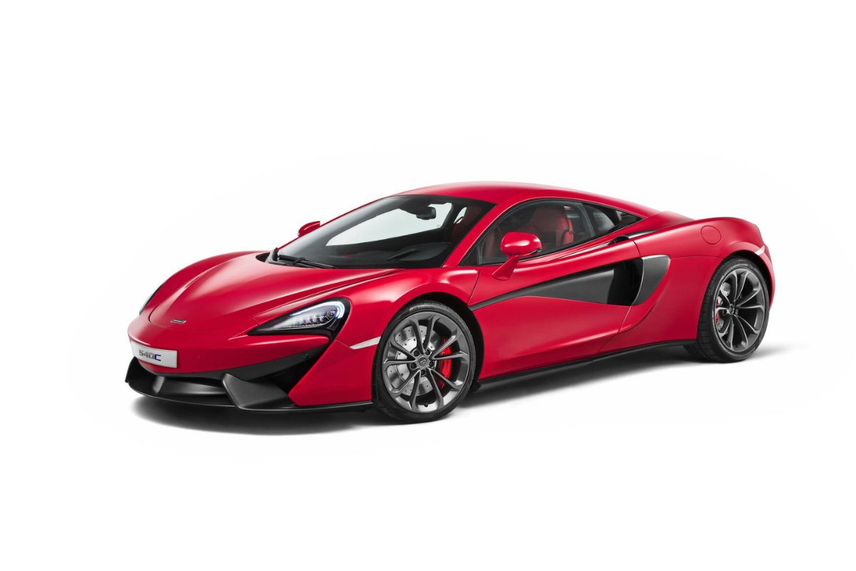 Side shot of red 2021 McLaren 540C, isolated on white background.