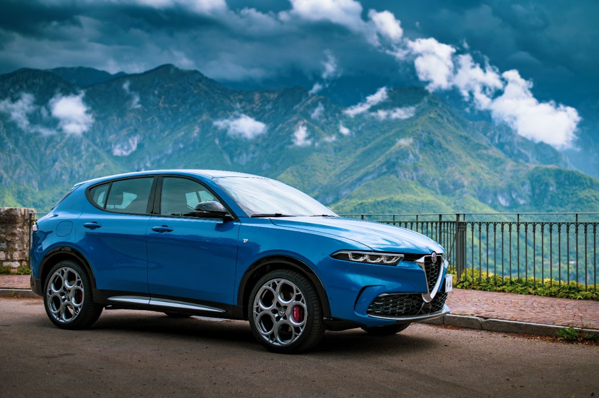 Blue 2022 Alfa Romeo on road near mountain.