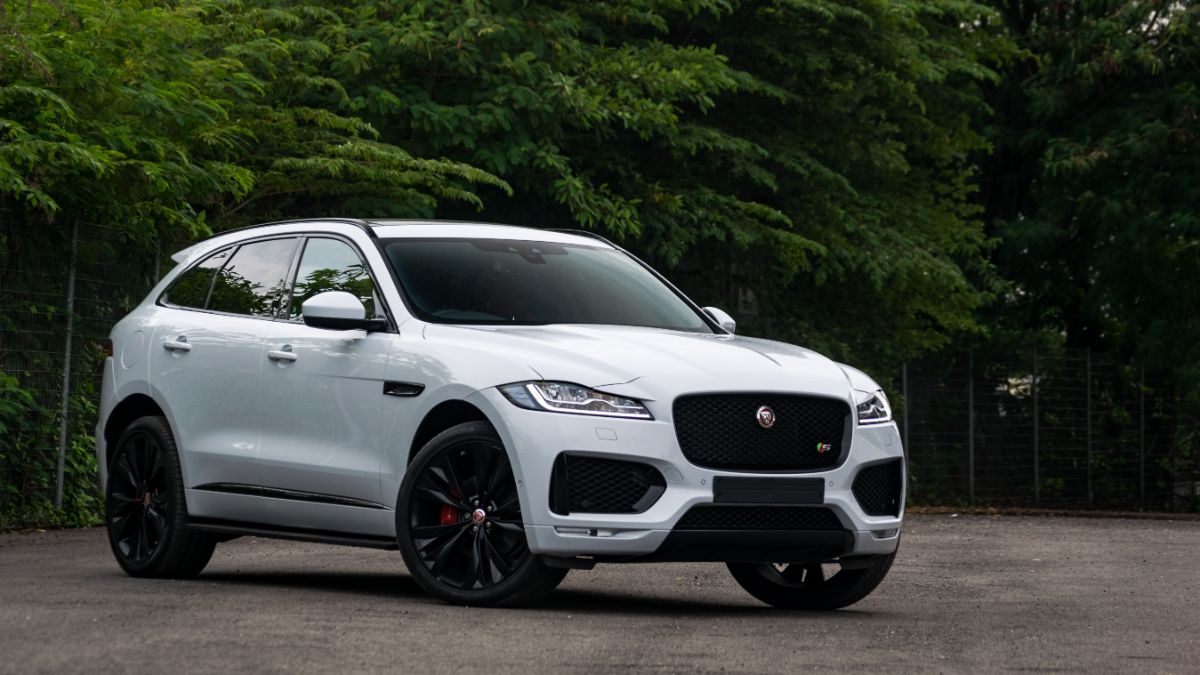 White 2022 Jaguar F-Pace parked in an open area.