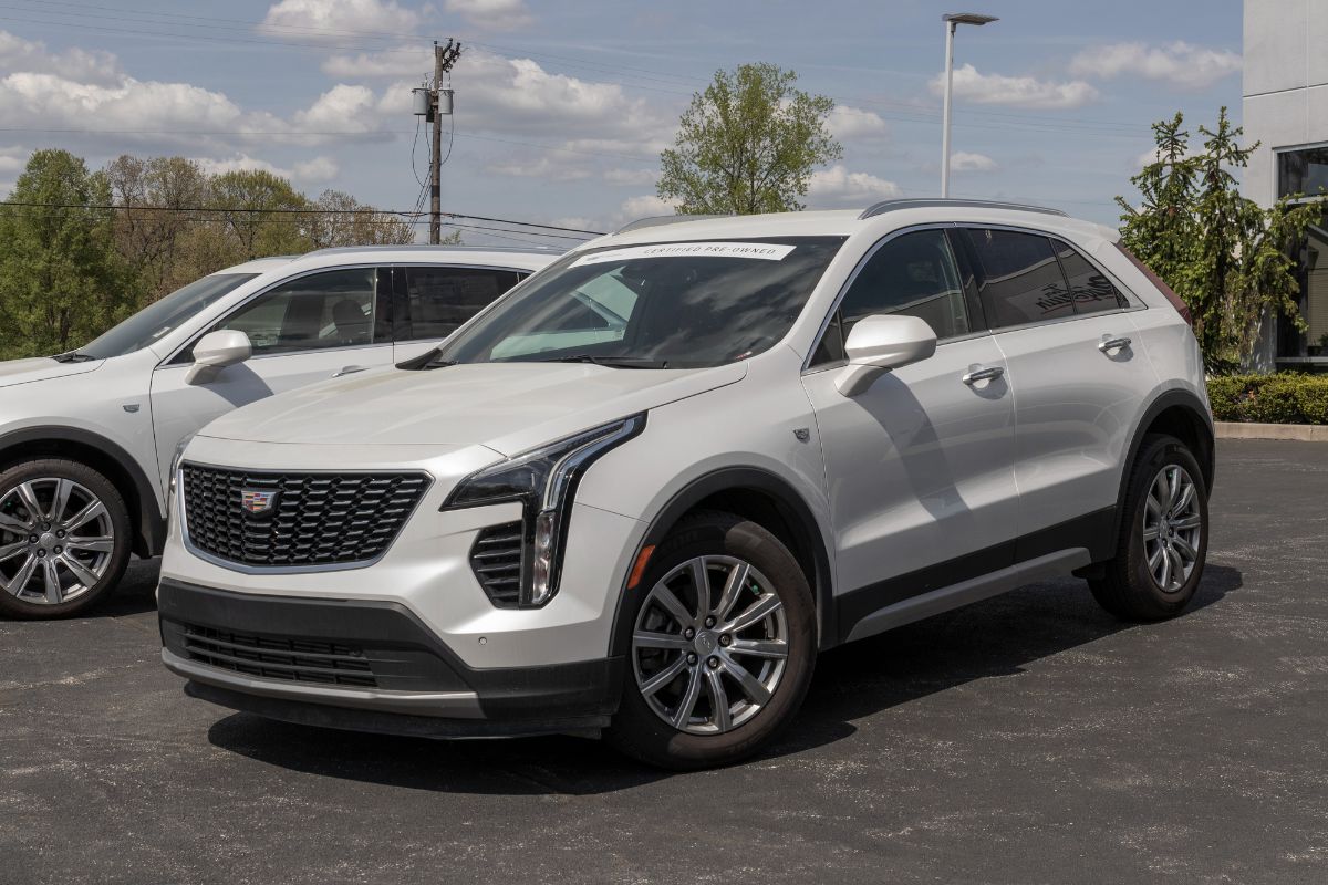 White 2022 XT5 Cadillac on parking space.