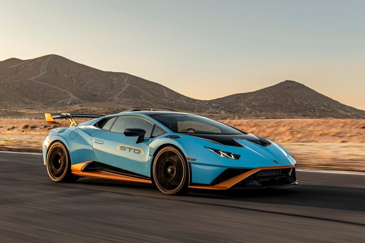 A photo of 2022 Lamborghini Huracán sports car driving on the desert place.