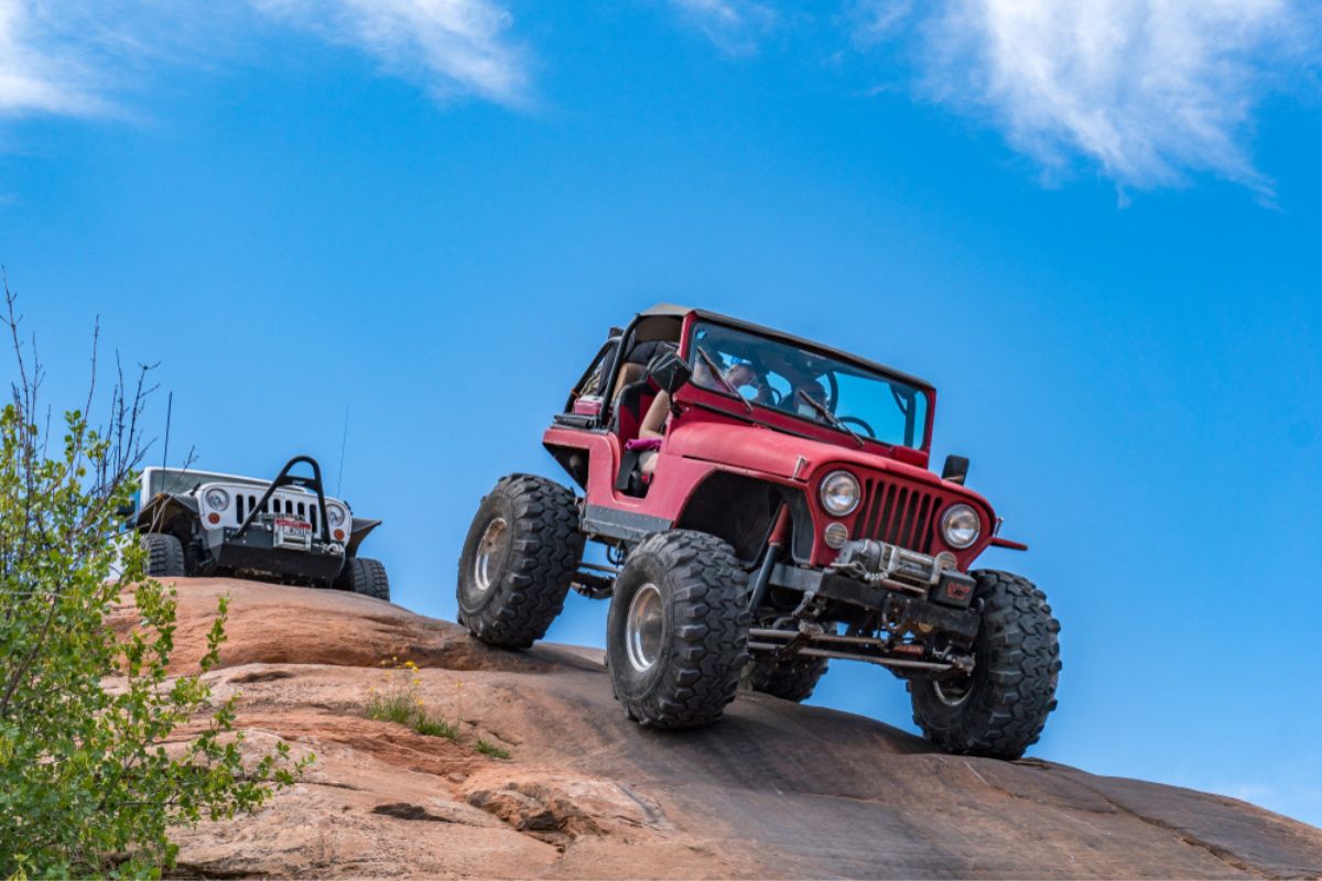 Near Moab, Utah, USA - 5/26/17 A modified Jeep Wrangler on sandstone.