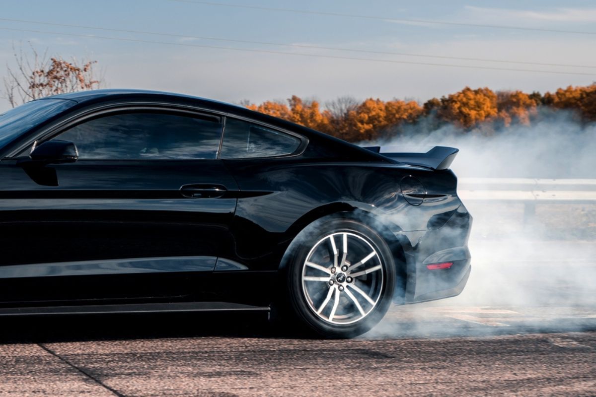 Muscle car Ford Mustang doing a burnout.