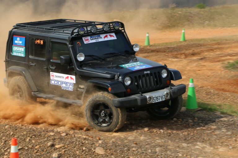 A black jeep wrangler on the field.