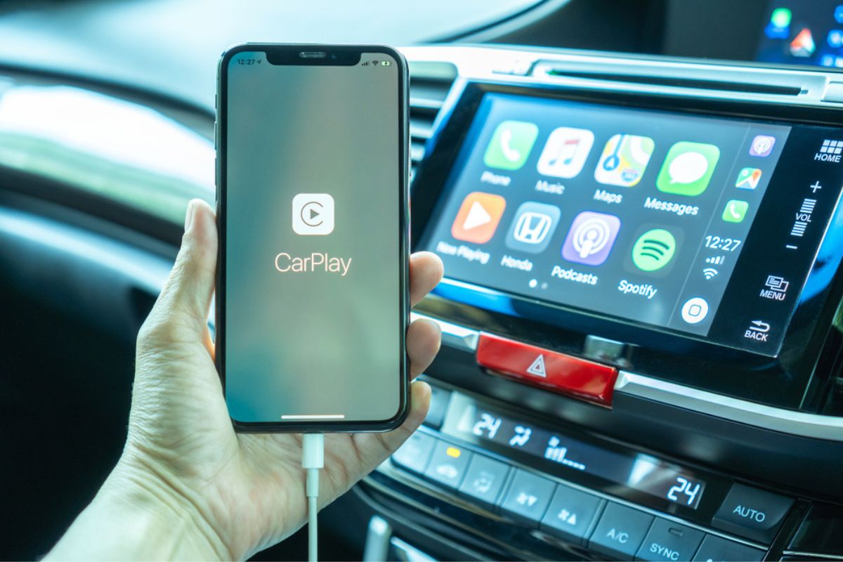 Apple CarPlay app on iPhone X, smart mobile application connected to Honda car for travel map, hand free phone call, online music on transportation vehicle safety.