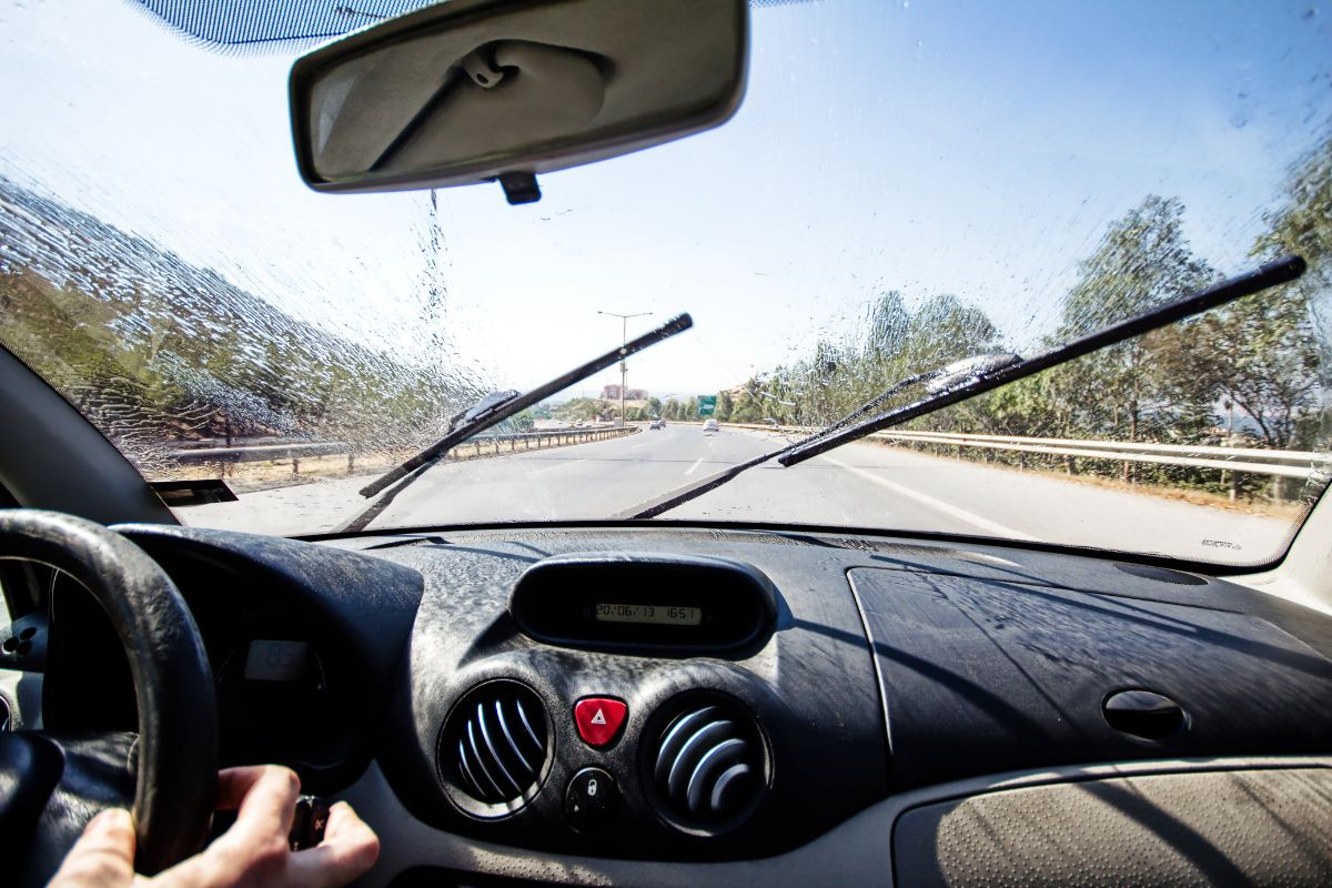 Activated windshield wipers on car.