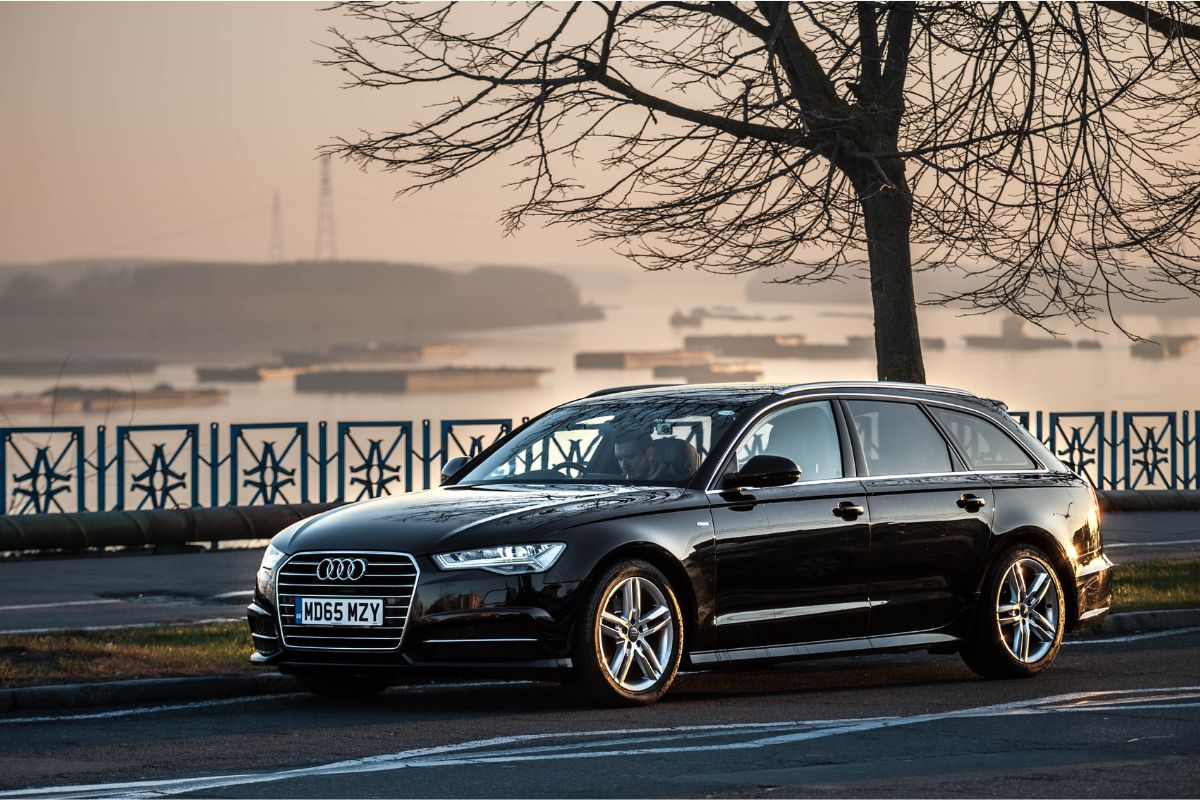 Front and view of the Audi A6 facelift with a stunning sunset-colored backdrop.