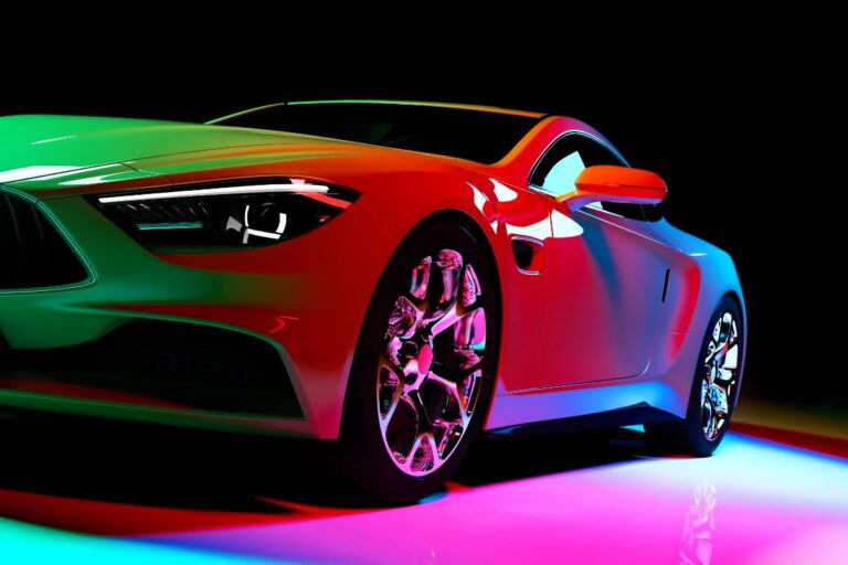 Modern coupe automobile against a dark background with multicolored lamps.