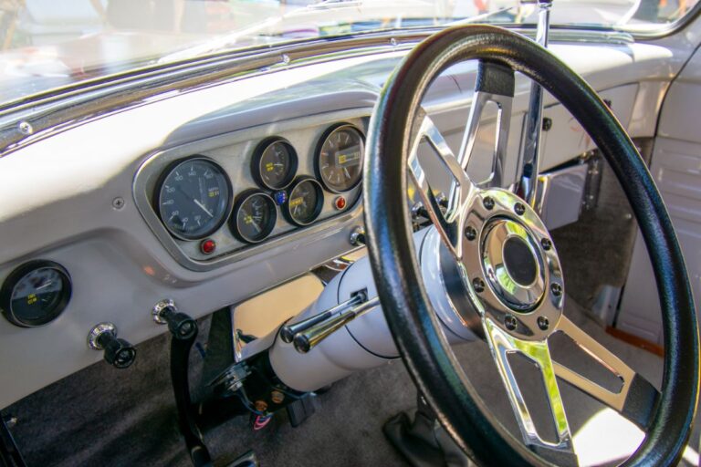 A classic retro shot of a vintage vehicle's interior steering wheel system and navigations.