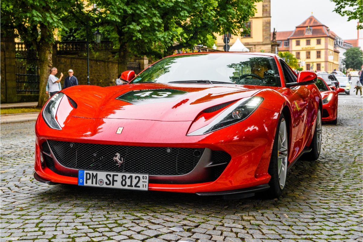 A red, rear-wheel-drive grand tourer with a front mid-engine is a FERRARI 812 SUPERFAST Type F152M.