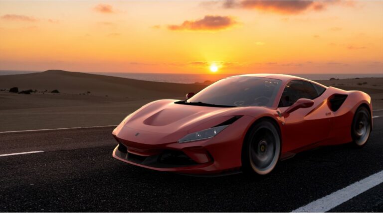 Side view of a maroon Ferrari F8 Tributo in desert road at sunrise.