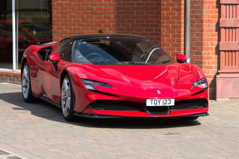 In front of a Ferrari showroom is a Ferrari SF90 Assetto Fiorano.