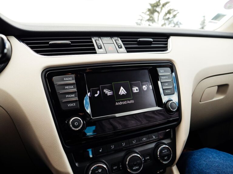 Google Android Auto on the new luxury car dashboard digital screen display showing the icons and large text Android Auto during menu selection.