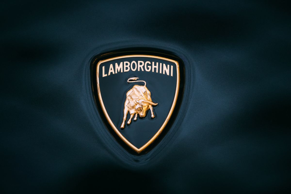 Close up photo of a Lamborghini Logo isolated in a black background.