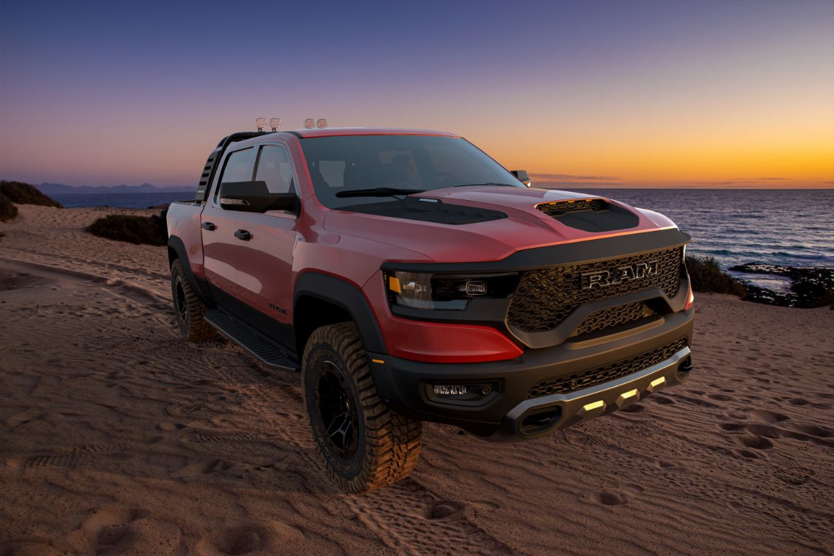 A picture of a red pickup vehicle against a stunning backdrop.