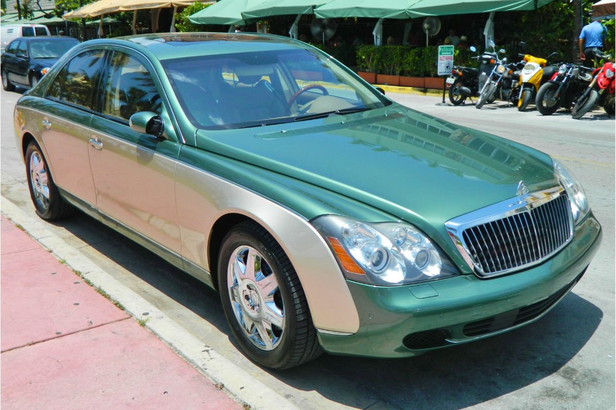 A green and gold luxury vehicle seen from the front.