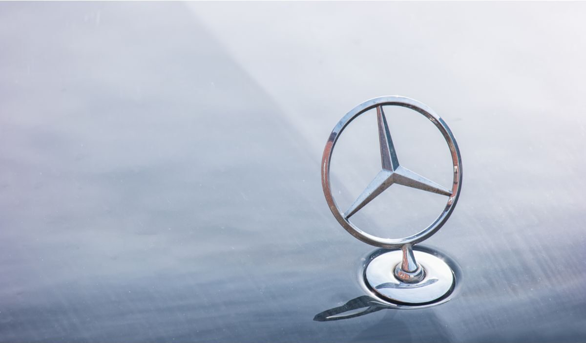 A Mercedes Benz logo installed in a silver vintage Mercedes Benz vehicle. 