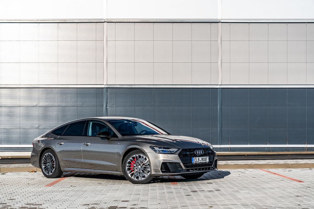 Side shot of Audi A7 car displayed outside of a establishment.