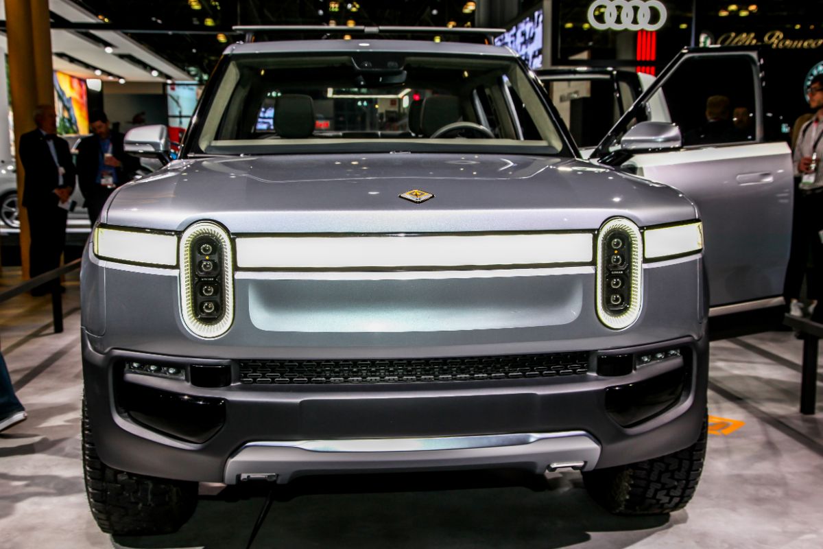 Close-up shot of Rivian R1T car at the auto show, front view.