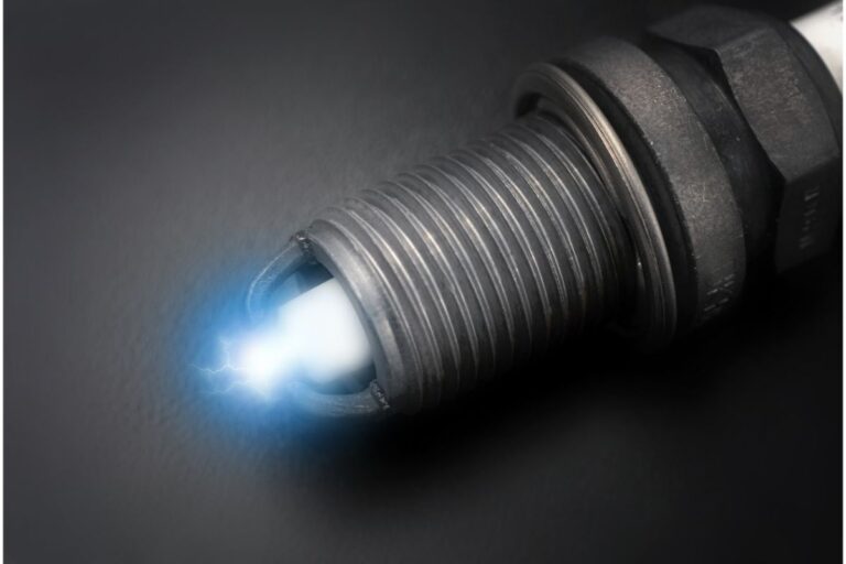 Close-up of a spark plug on a black background.