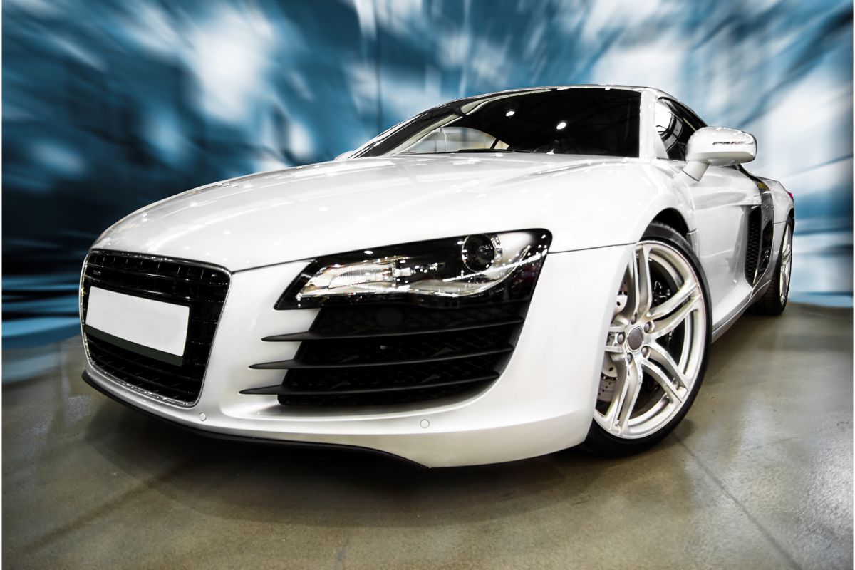 Motion photo of a white sports car with a blurry background.