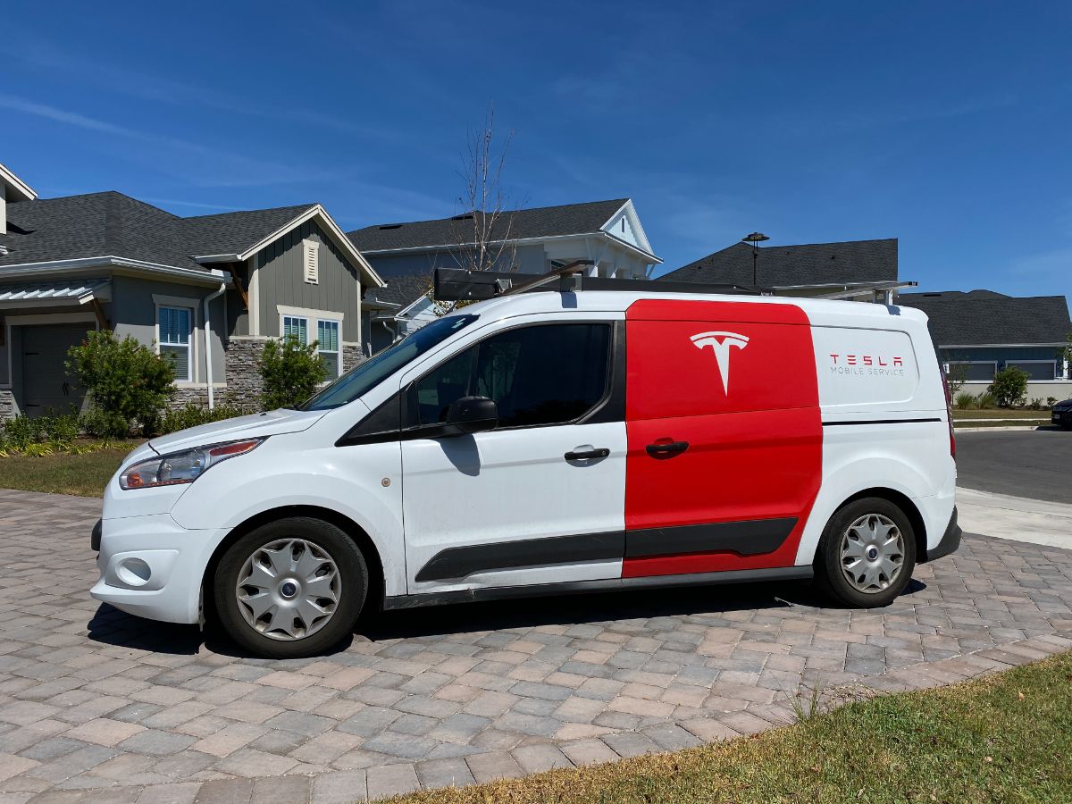 A Tesla repair truck service in the driveway.