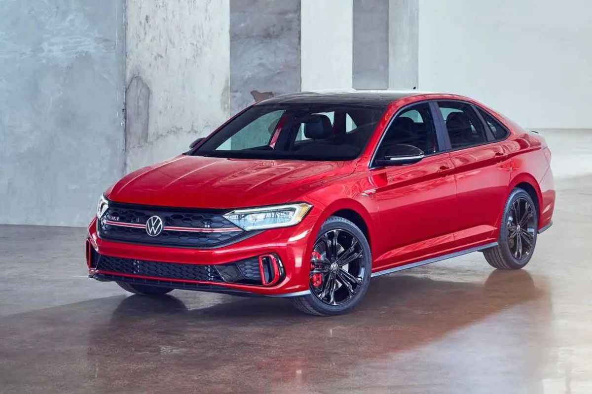 A brand new Volkswagen Jetta in red colorway parked inside a building.