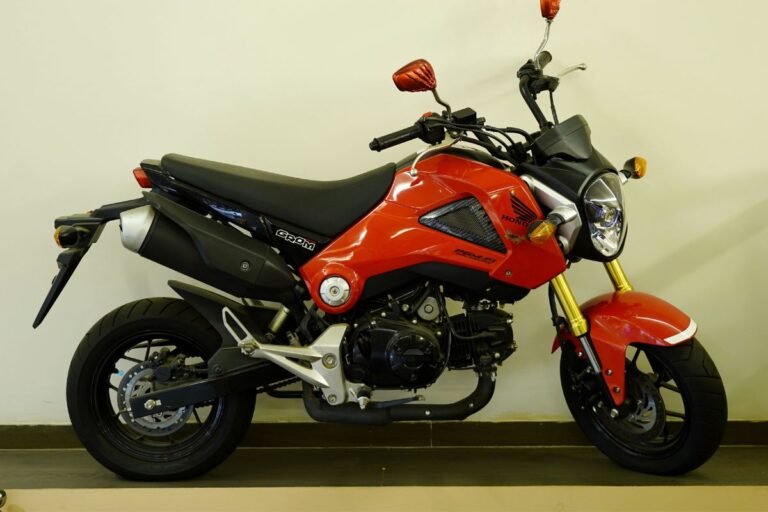 Side view angle of a brand new Honda Grom in red and black colorway.