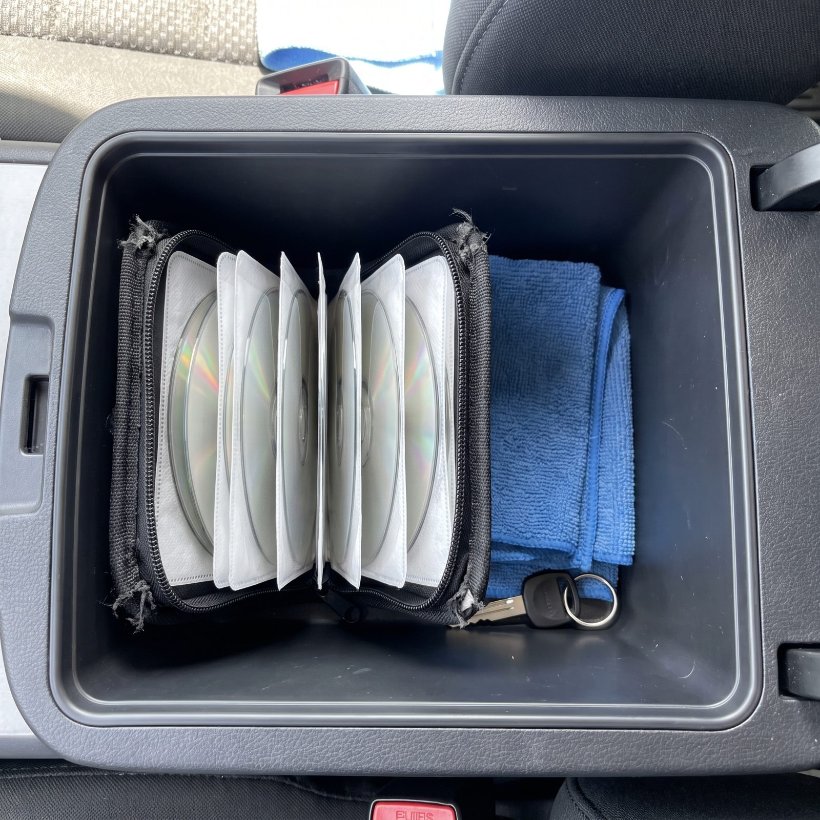 A CD Wallet Tucked in the Console, Discs Still in Order