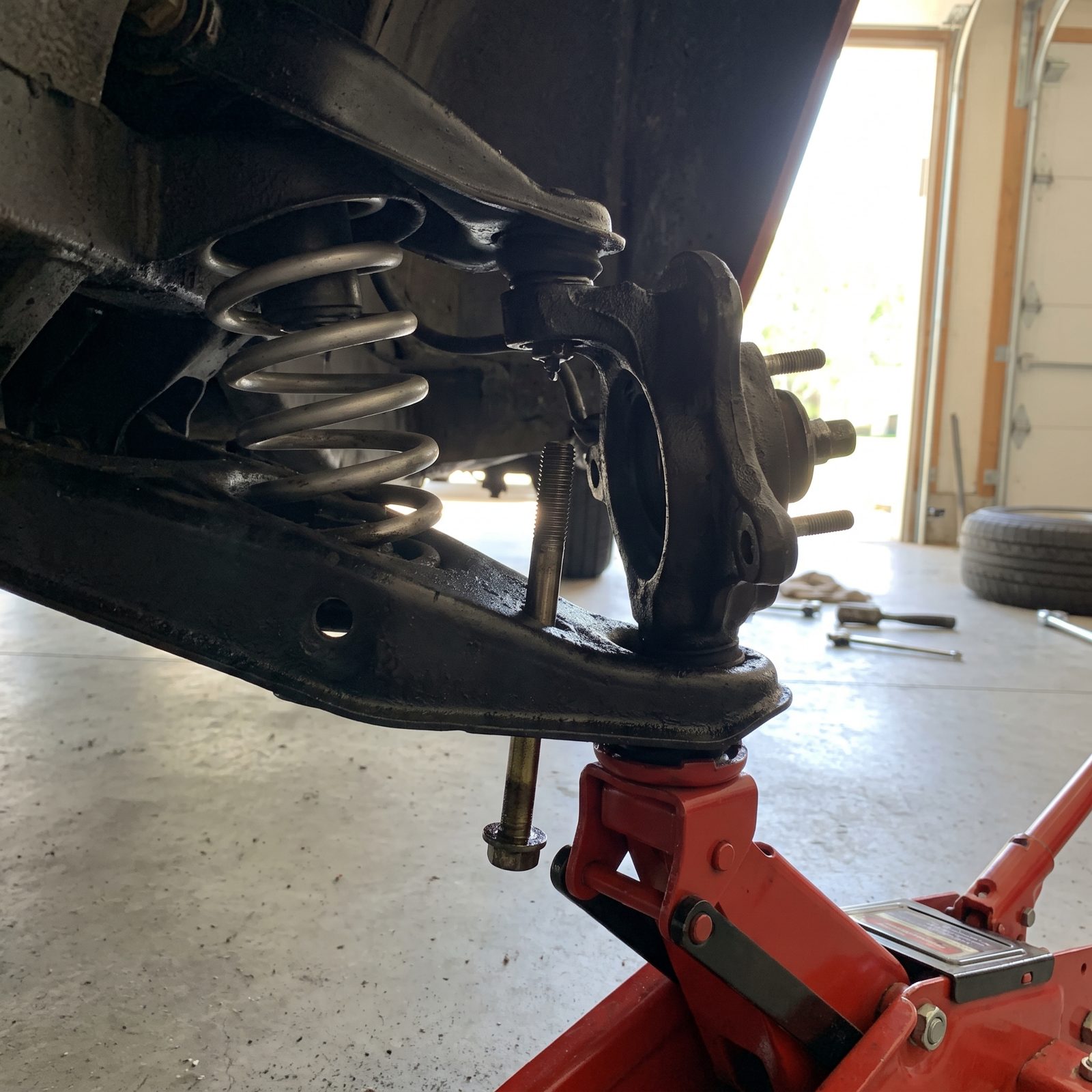 Pump a Floor Jack to Coax Suspension Bolt Holes Into Line