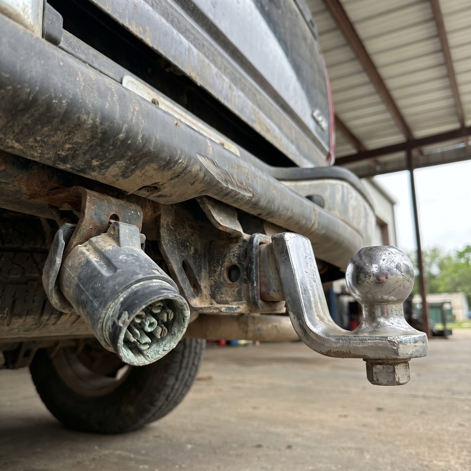 A Scuffed Hitch Ball and a Green, Corroded Trailer Plug Mean This Car Worked for a Living